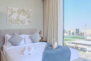 a hotel room with a bed and a large window at Stella Stays King Fahd - Furnished Apartments in Riyadh +35 photos