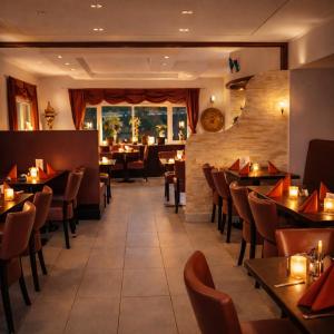 a restaurant with tables and chairs and a large window at Ata Hotel - Self Check-in in Hamburg