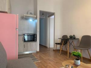 a living room with a table and a microwave at Athina Central Corfu Town Apartment in Ágios Rókkos