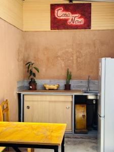 a kitchen with a counter with a sink and a refrigerator at Casa Ñawi in San Pedro de Atacama +22 photos
