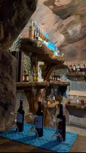 a bar with bottles and glasses on a table at Mawimbi Jiko Hotel in Taveta