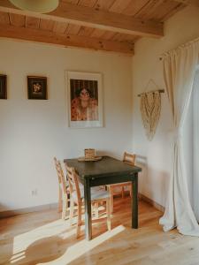 a dining room with a black table and chairs at Po Prostu Dobro in Mrągowo