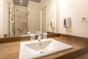 a bathroom with a sink and a shower at Hôtel d'Ossau in Laruns