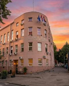 a building with two flags on top of it at BGD Downtown Hostel in Belgrade