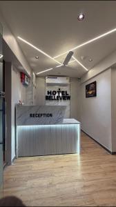 a reception area of a building with a reception desk at Hotel Belleview VASTRAPUR in Jāmb