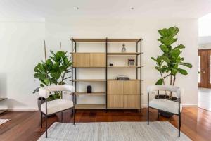 a living room with two chairs and a book shelf at A paradise with ocean views in Conil de la Frontera +23 photos