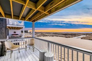 a balcony with chairs and a view of the beach at Stunning Bay Views | Beach Access - Deck - Parking in Provincetown