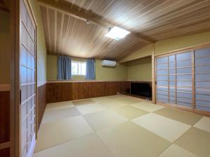 ein leerer Raum mit einem Fernseher und einer Decke in der Unterkunft まるごや 船でしか行けない離島の一棟貸し宿 in Hinase