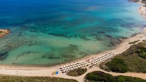 an aerial view of a beach with a row of umbrellas at Riva Marina Resort - CDSHotels in Carovigno