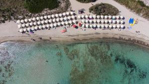an aerial view of a beach with a bunch of umbrellas at Riva Marina Resort - CDSHotels in Carovigno +85 photos