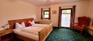 a bedroom with a bed and a chair in it at Jagersimmerl in Grünau im Almtal