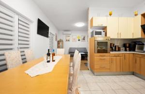 a kitchen and dining room with a wooden table at House Villa Zvonko Near NP Krka in Sedramić