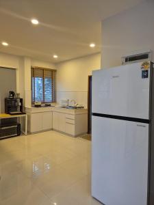 a kitchen with a white refrigerator in a room at Casa Amara in Ko Phangan +6 photos