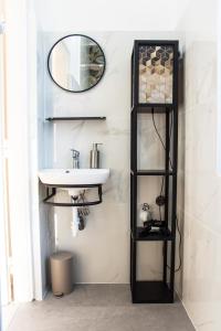 a bathroom with a sink and a mirror at BB Apartman Hajdúnánás in Hajdúnánás +11 photos
