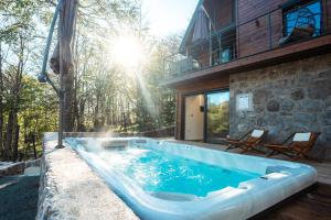 a pool in the backyard of a house at The Magic Forest - Holiday Home & Spa Zone Platak in Soboli