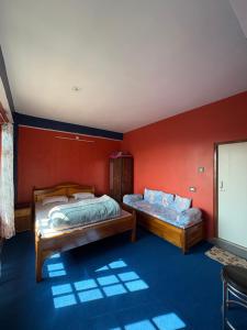 two beds in a room with red walls at Sameer Homestay in Kalimpong