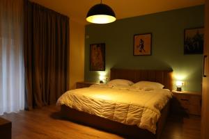 a bedroom with a large bed in a room at SMALL Boutique & Garden in Tirana +79 photos