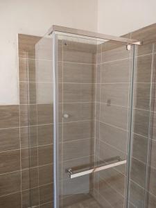 a shower with a glass door in a bathroom at Donido's Place in Alberton