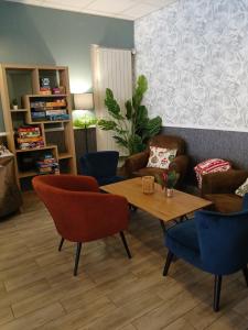 a living room with a table and chairs at Chez Les Papa's in Aspres-sur-Buëch
