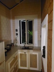 a kitchen with a sink and a window at Stay Zen in Arangala