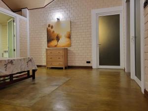 a room with a dresser and a painting on the wall at Stay Zen in Arangala
