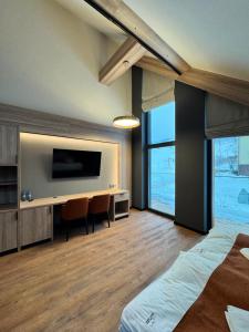 a bedroom with a flat screen tv and a bed at Ski and Bike Residence in Istebna