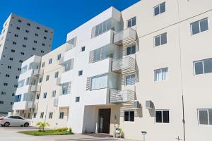 an exterior view of a white building with balconies at Seu Refúgio em Cuiabá in Cuiabá