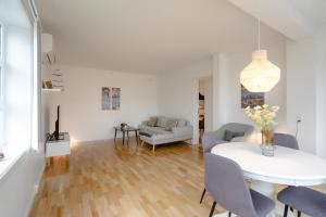 a living room with a white table and a couch at Sallinnguit in Sisimiut