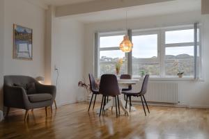 a dining room with a table and chairs and a window at Sallinnguit in Sisimiut