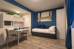 a bedroom with a bed and a table with chairs at Casa Corallina Parma in Parma