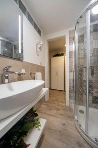 a bathroom with a sink and a shower at Casa Corallina Parma in Parma
