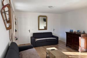 a living room with a couch and a mirror at Mountain getaway in Saint-Chaffrey in Saint-Chaffrey