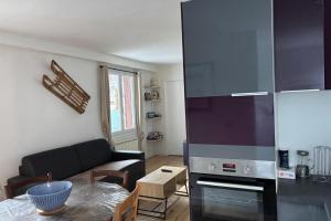 a living room with a couch and a kitchen at Mountain getaway in Saint-Chaffrey in Saint-Chaffrey