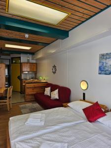 a bedroom with a bed and a red couch at Hotel Asperner Löwe in Vienna +53 photos