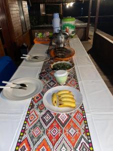 a table with plates of bananas on a table at Raja Ampat Holidays in Besir
