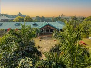 a building with a green roof and some palm trees at Hotel Sarai Bharatgarh in Nohan