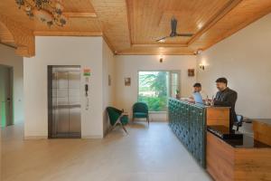 two people sitting at a bar in a room at Hotel Sarai Bharatgarh in Nohan