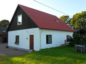 a white and red house with a red roof at Vindslägenhet på Bjäre in Båstad