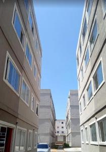 two tall buildings next to each other on a street at Przibilwiez Hause in João Pessoa +5 photos