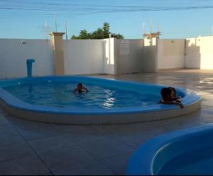 two children are swimming in a pool in a swimming pool at Przibilwiez Hause in João Pessoa