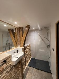 a bathroom with a sink and a shower at Auberge des Riders in Loze +15 photos