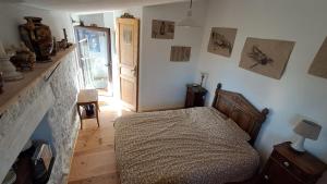 a bedroom with a bed and a fireplace at Chambre de la roche trouee GR49 in Trigance