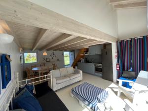 a living room with a couch and a table at Aljezur Houses 3 bedrooms 2 bathrooms with Condo Pool in Aljezur +16 photos