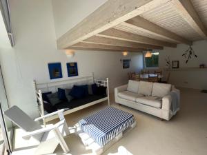 a living room with a couch and a table at Aljezur Houses 3 bedrooms 2 bathrooms with Condo Pool in Aljezur