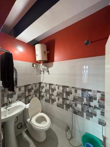 a bathroom with a toilet and a sink at Sameer Homestay in Kalimpong