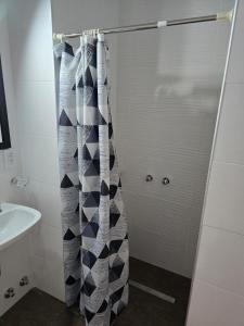 a bathroom with a shower curtain and a sink at Hotel KEY´S in Buenos Aires