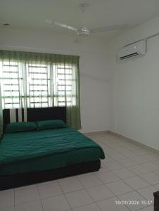 a bedroom with a green bed and a window at Seberang Jaya Family Pool Homestay Near Hospital 3 Bedroom Aircond 2 Bathroom & Family Room Aircond in Perai +44 photos