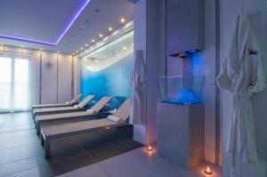 a row of benches in a room with lights at Arany Bárány Hotel in Zalaegerszeg