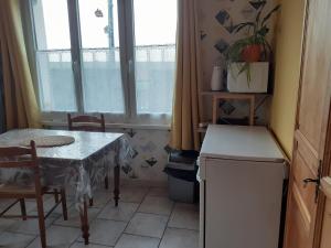 a small kitchen with a table and a window at Studio du gite in Wavrans-sur-lʼAa