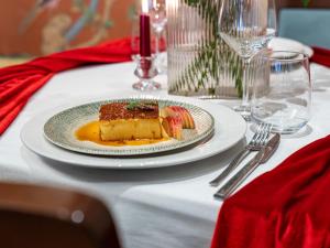 a plate with a piece of cake on a table at Hotel Buchenland in Gura Humorului